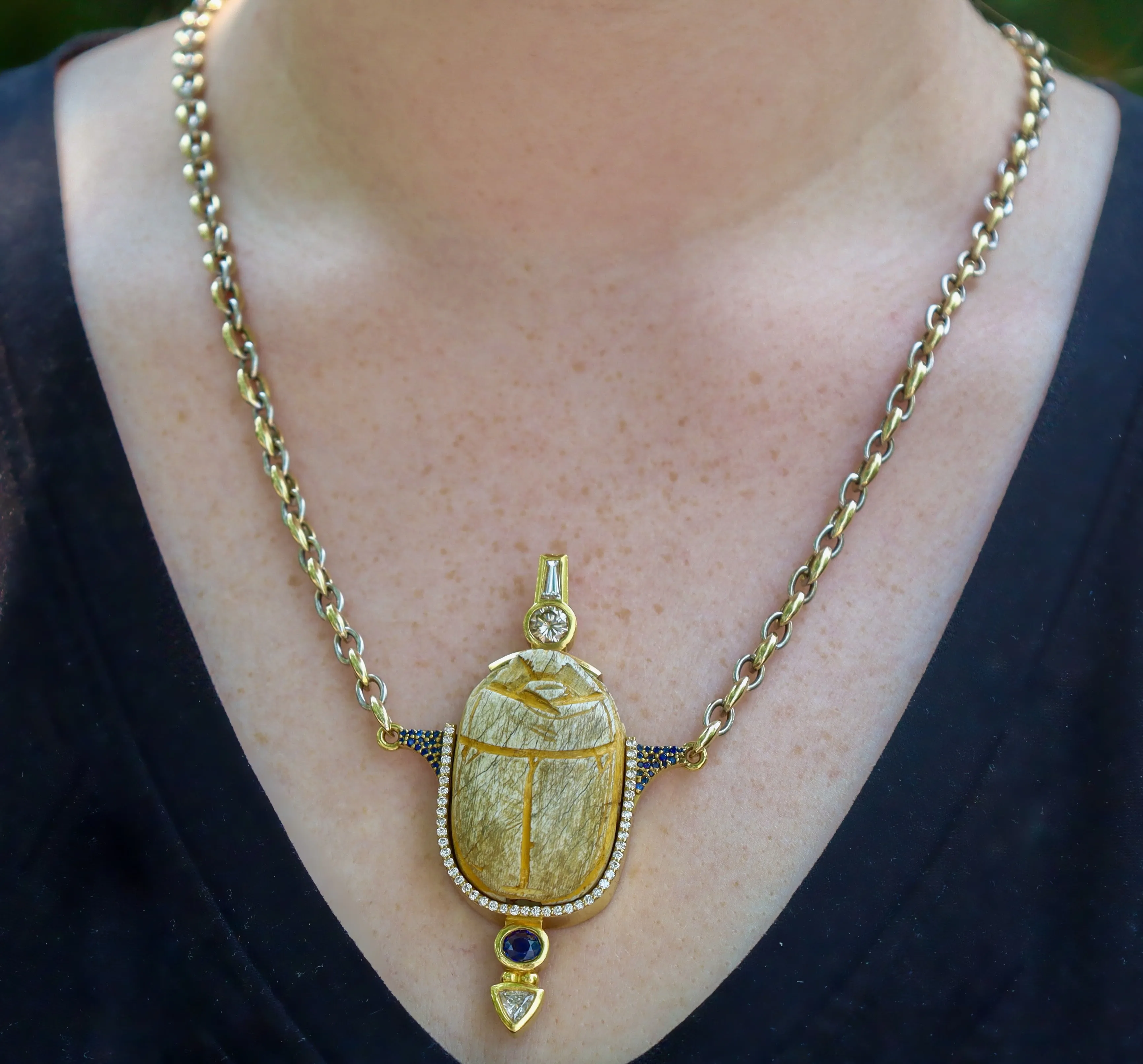 18K Yellow Gold Necklace: 3000 Yr. Old Scarab set in 22K Yellow Gold Frame w/Diamonds and Sapphire Accents