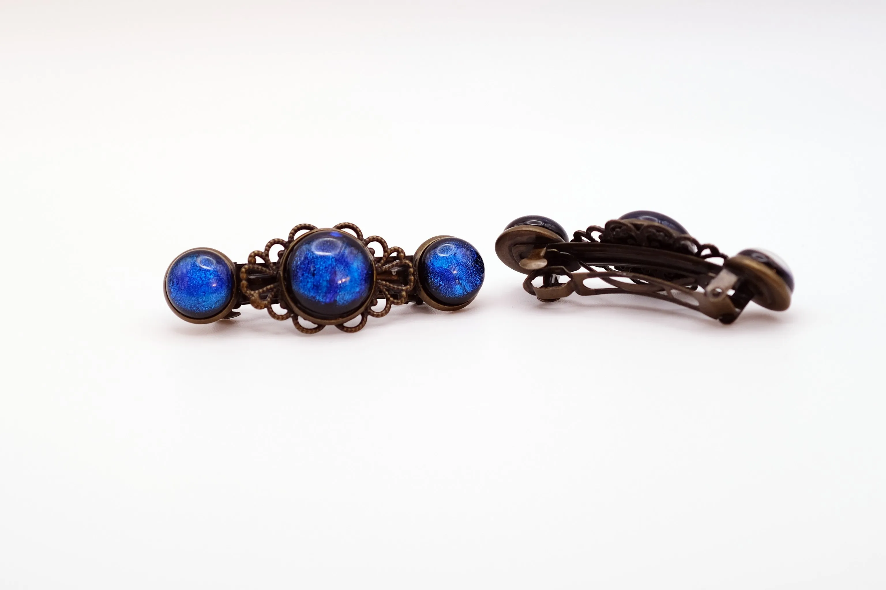 Barrette pair, bronze flowers with blue dichroic fused glass cabochons, french clip, 2 1/4 inches