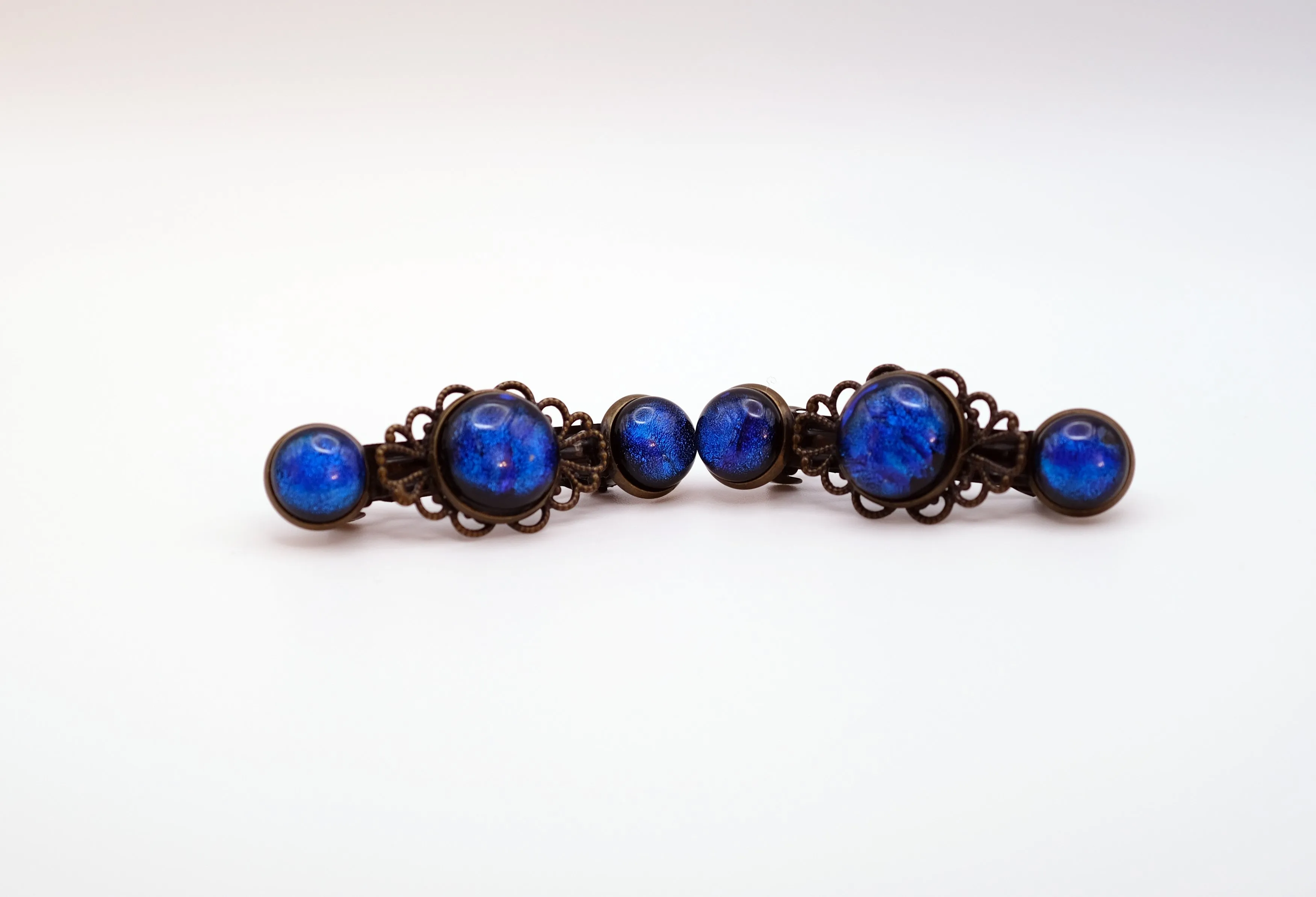 Barrette pair, bronze flowers with blue dichroic fused glass cabochons, french clip, 2 1/4 inches